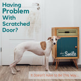 dog standing next to scratched door with message
